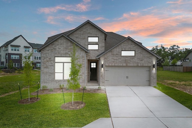 408 Ridgewell Loop, Georgetown, TX 78633 - view of front of house featuring brick siding, an attached garage, concrete driveway, and a lawn