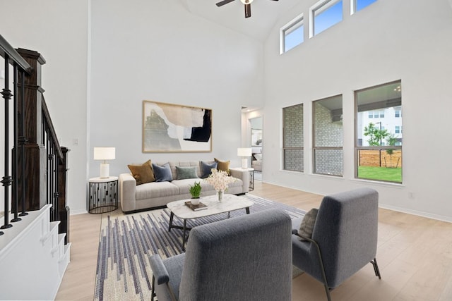 408 Ridgewell Loop, Georgetown, TX 78633 - living area with high vaulted ceiling, a ceiling fan, light wood-style flooring, and stairs