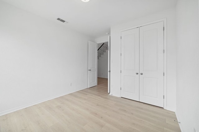 408 Ridgewell Loop, Georgetown, TX 78633 - unfurnished bedroom with light wood-type flooring, a closet, and baseboards