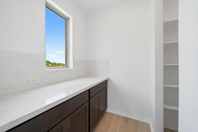 408 Ridgewell Loop, Georgetown, TX 78633 - bathroom featuring wood finished floors and backsplash