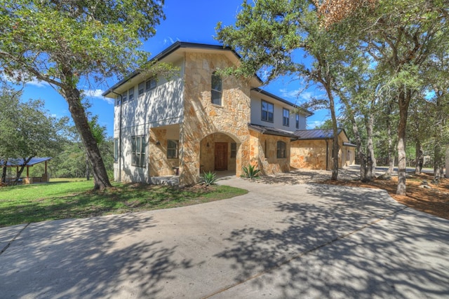 mediterranean / spanish-style house with a garage and a front yard