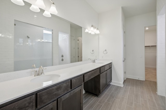 bathroom with vanity and a tile shower