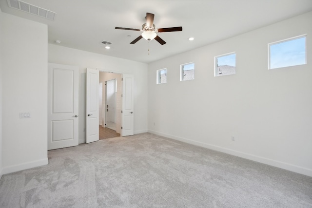 unfurnished bedroom with ceiling fan and light carpet