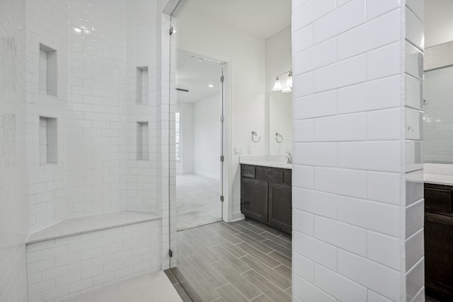 bathroom featuring vanity and a tile shower