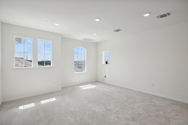 spare room featuring light colored carpet