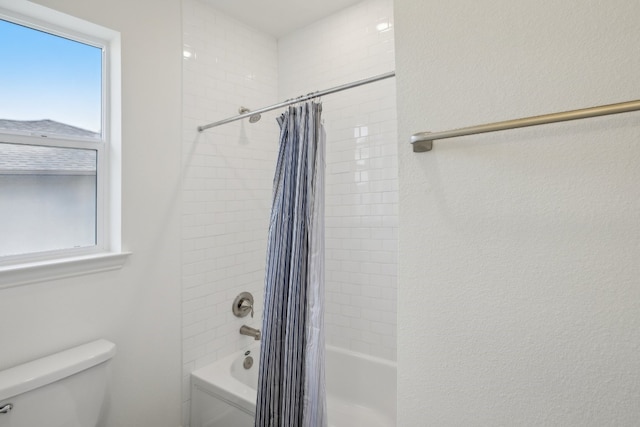 bathroom featuring shower / tub combo with curtain and toilet