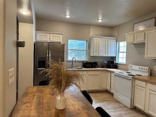 kitchen with white electric range, sink, stainless steel fridge with ice dispenser, and wooden counters