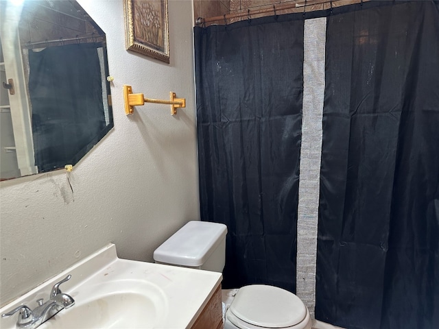 bathroom with vanity, toilet, and a shower with shower curtain