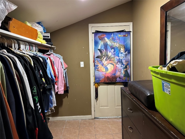 spacious closet with lofted ceiling and light tile patterned floors