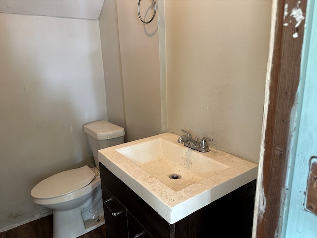 bathroom featuring vanity, hardwood / wood-style floors, and toilet