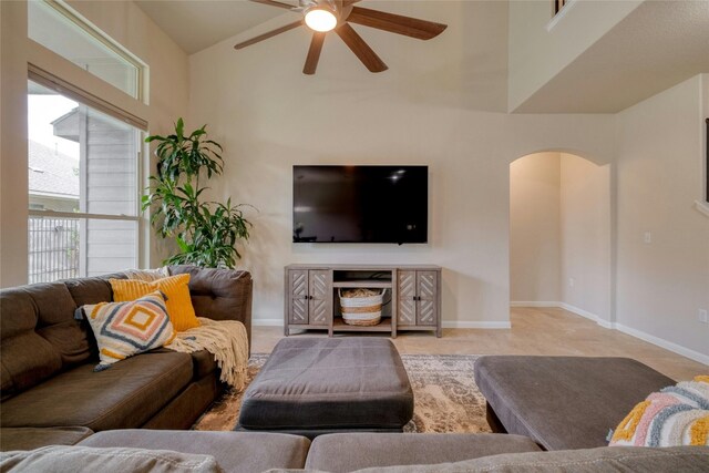 living room featuring ceiling fan and high vaulted ceiling