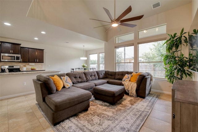 living room featuring light tile patterned flooring and ceiling fan