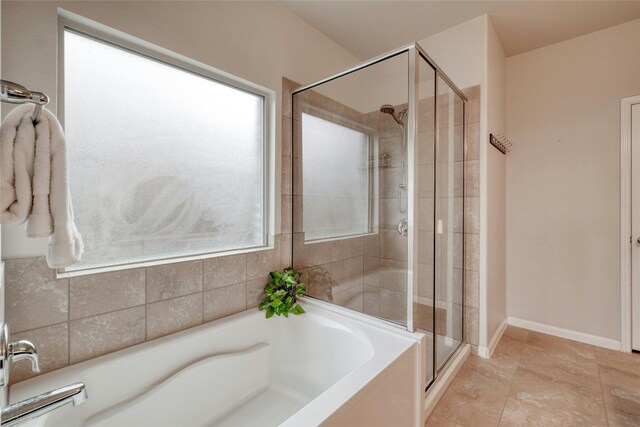 bathroom with separate shower and tub and plenty of natural light