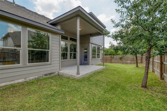 back of house featuring a yard and a patio