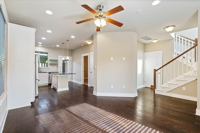 unfurnished living room with ceiling fan and dark hardwood / wood-style floors