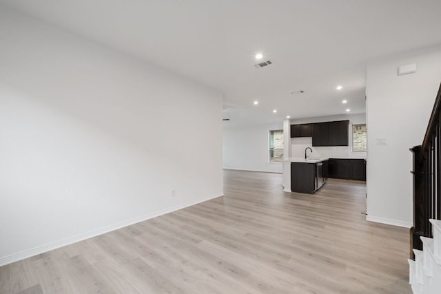 537 Raleigh Dr, Georgetown, TX 78633 - unfurnished living room featuring stairway, light wood-style floors, and recessed lighting