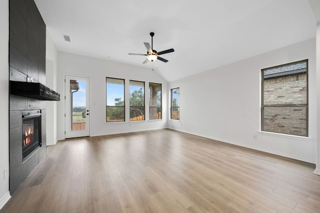 537 Raleigh Dr, Georgetown, TX 78633 - unfurnished living room featuring ceiling fan, a tile fireplace, light wood-style floors, and baseboards