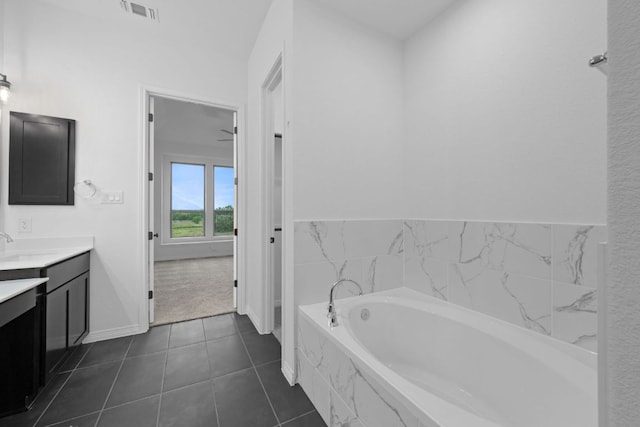 537 Raleigh Dr, Georgetown, TX 78633 - bathroom featuring vanity, baseboards, a garden tub, and tile patterned floors