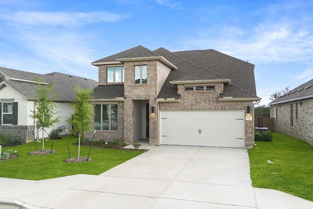 537 Raleigh Dr, Georgetown, TX 78633 - view of front of property featuring brick siding, driveway, roof with shingles, a garage, and a front lawn