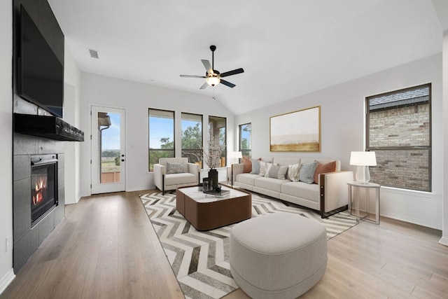 537 Raleigh Dr, Georgetown, TX 78633 - living room featuring a tile fireplace, light wood-type flooring, and ceiling fan