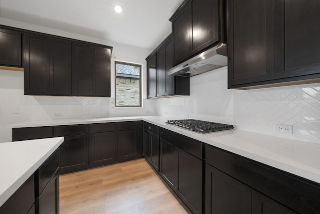 537 Raleigh Dr, Georgetown, TX 78633 - kitchen featuring under cabinet range hood, decorative backsplash, stainless steel gas stovetop, and light countertops