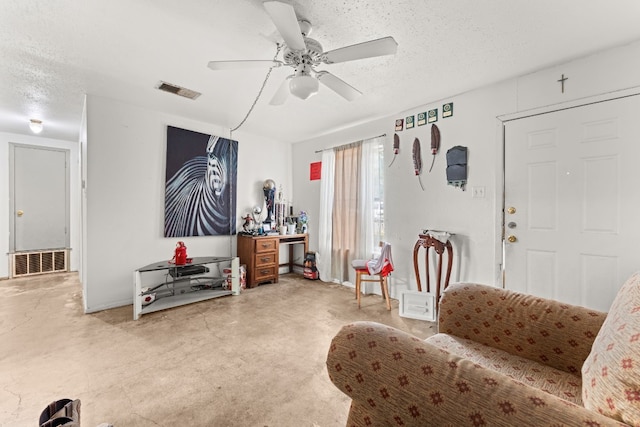 living room with ceiling fan and a textured ceiling