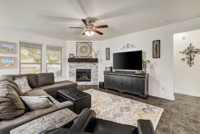 living room with ceiling fan and a fireplace