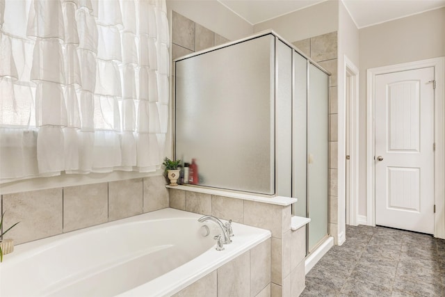 bathroom featuring shower with separate bathtub