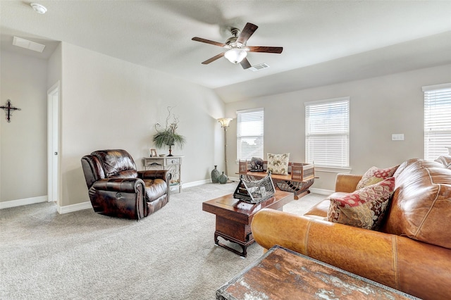 carpeted living room with ceiling fan, a wealth of natural light, and lofted ceiling