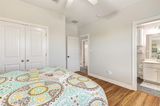 bedroom with ensuite bath, sink, hardwood / wood-style flooring, a closet, and ceiling fan