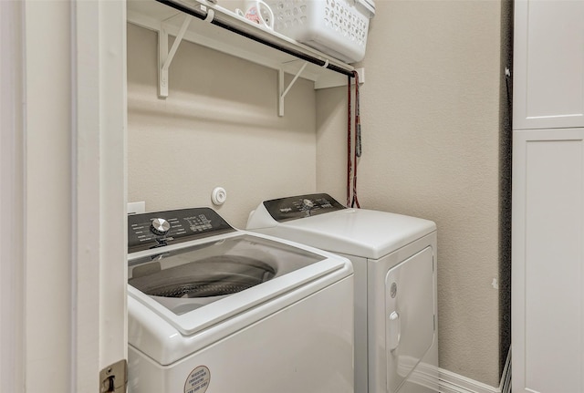 laundry room with separate washer and dryer