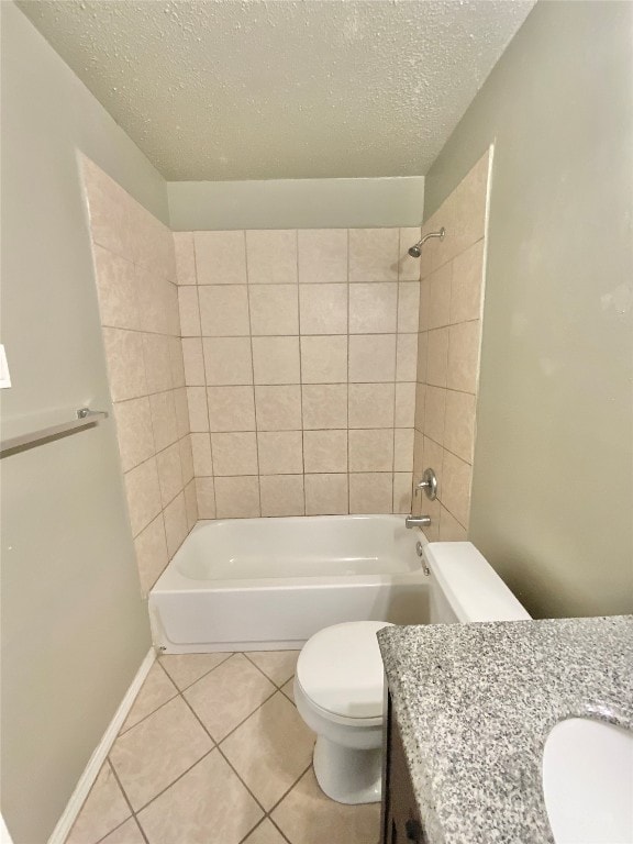 full bathroom with vanity, tile patterned floors, tiled shower / bath, toilet, and a textured ceiling