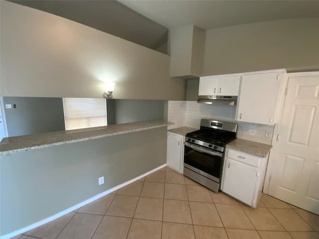 kitchen with white cabinetry, kitchen peninsula, decorative backsplash, light tile patterned flooring, and stainless steel range with gas stovetop