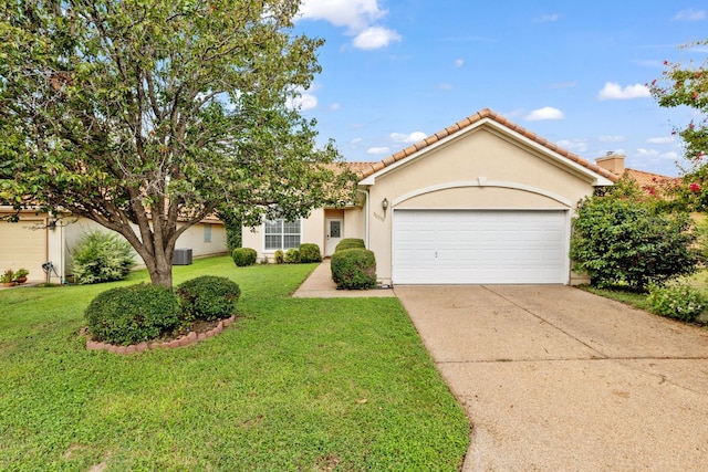 view of front facade featuring a front yard, a garage, and central AC