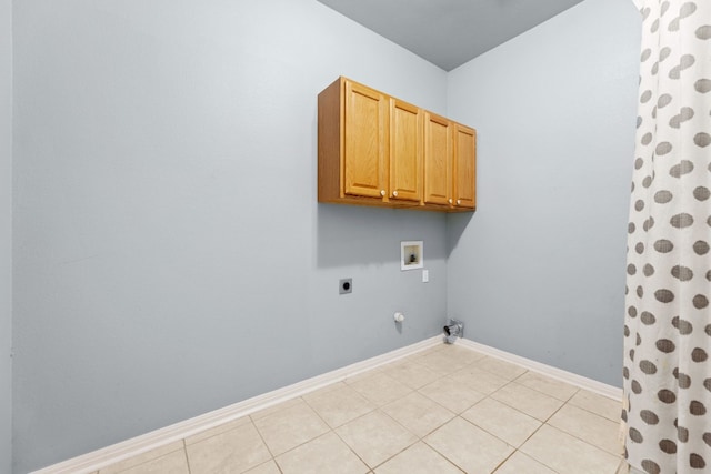 laundry room featuring light tile patterned floors, hookup for an electric dryer, hookup for a gas dryer, cabinets, and hookup for a washing machine