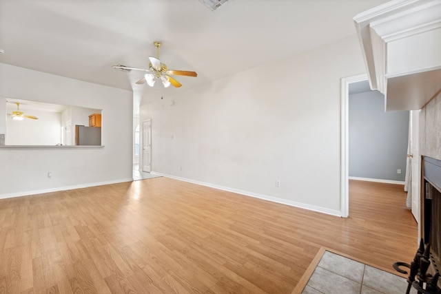 unfurnished living room with light wood-type flooring and ceiling fan