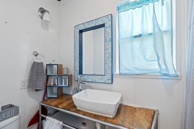 bathroom with sink, plenty of natural light, and toilet