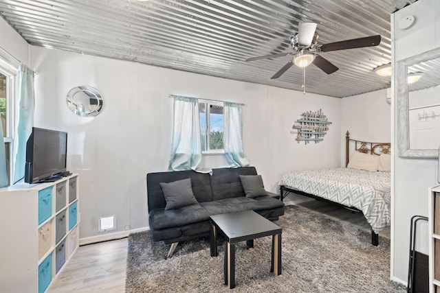 bedroom with ceiling fan and hardwood / wood-style floors