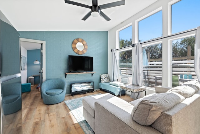 living room featuring a fireplace, hardwood / wood-style flooring, plenty of natural light, and ceiling fan