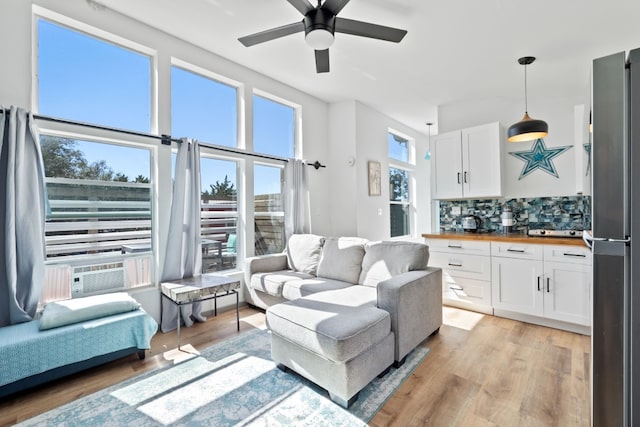 living room featuring light hardwood / wood-style floors and ceiling fan