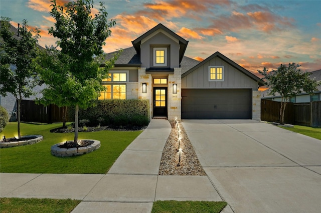 view of front of home with a yard and a garage