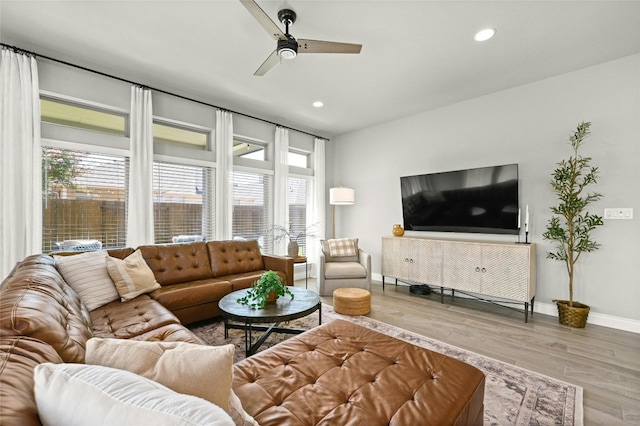 living room featuring ceiling fan and light wood-type flooring