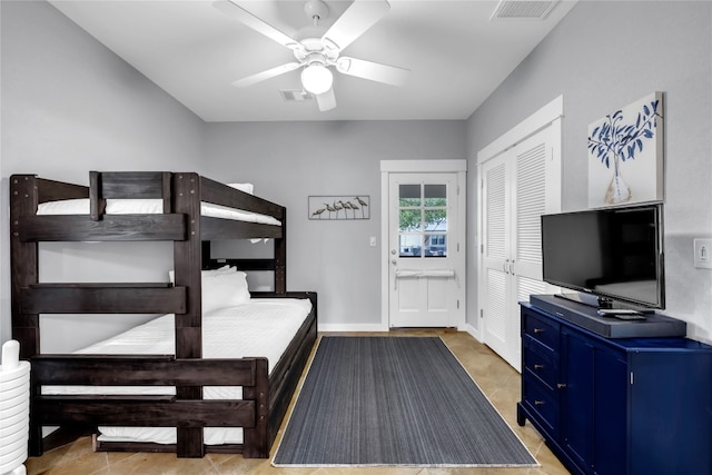 bedroom with a closet, tile patterned flooring, and ceiling fan