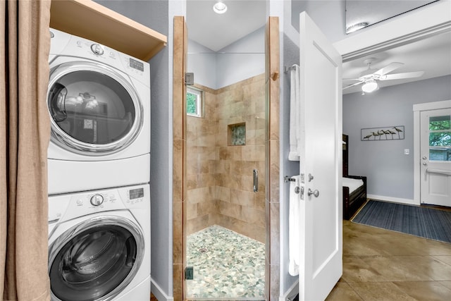 laundry room with tile patterned flooring, ceiling fan, and stacked washer / drying machine