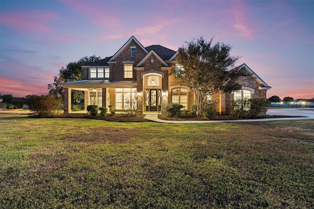 french provincial home featuring a front yard and french doors