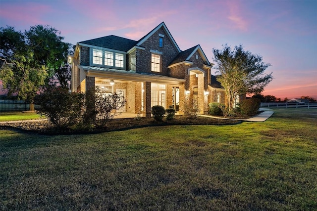 view of front of house featuring fence and a front yard