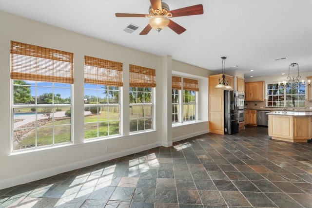 kitchen featuring pendant lighting, ceiling fan, appliances with stainless steel finishes, and a healthy amount of sunlight