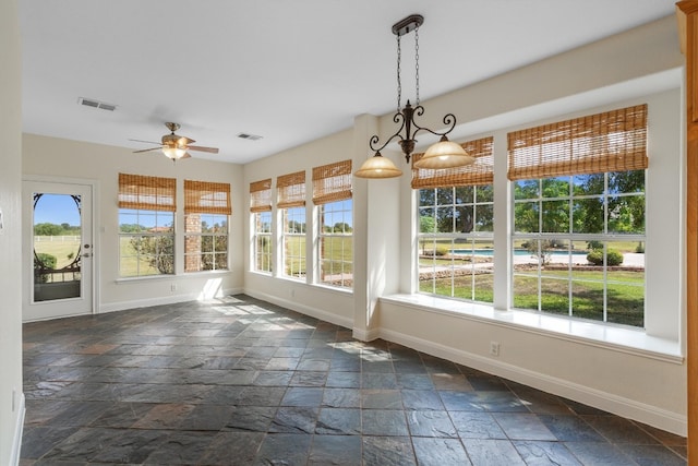 interior space with ceiling fan