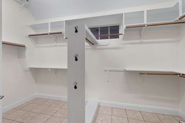 spacious closet with light tile patterned floors