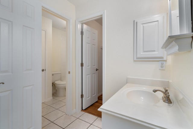 bathroom featuring vanity, tile patterned flooring, and toilet